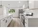 Bright, open kitchen with stainless steel appliances, shaker cabinets, and large island at 8933 W 1050 S, Fortville, IN 46040