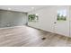 Bright and airy living room featuring luxury vinyl plank flooring and a stylish accent wall at 8933 W 1050 S, Fortville, IN 46040