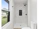 Brightly lit marble shower with matte black fixtures and storage nook at 8933 W 1050 S, Fortville, IN 46040