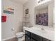 Bright bathroom features modern vanity, framed mirror, cheerful decor and convenient shelving unit for storage at 918 Cass Dr, Franklin, IN 46131
