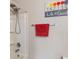 Close-up of a shower/bath showcasing sleek fixtures, a red towel, and the 'Life is Good' wall art at 918 Cass Dr, Franklin, IN 46131