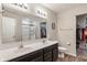 Bathroom featuring a double sink vanity with a view into the walk-in closet and shower at 918 Cass Dr, Franklin, IN 46131