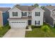 Charming two-story home with a well-manicured lawn, attached garage, and inviting curb appeal at 918 Cass Dr, Franklin, IN 46131