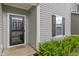 Close-up of the front door with gray siding, black shutters, and a welcome mat at 918 Cass Dr, Franklin, IN 46131