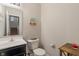 Cozy half bathroom featuring a sleek vanity and a decorative mirror at 918 Cass Dr, Franklin, IN 46131