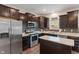 The kitchen features stainless steel appliances, stylish backsplash, and wood flooring at 918 Cass Dr, Franklin, IN 46131