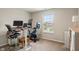 Home office area with ergonomic chair, adjustable desk, and stationary bike at 918 Cass Dr, Franklin, IN 46131