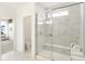 Elegant bathroom showcasing a glass shower, marble tile and adjacent toilet room at 9351 Abner St, McCordsville, IN 46055