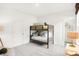 Bedroom featuring bunk beds, a modern lamp, and ensuite closet at 9351 Abner St, McCordsville, IN 46055