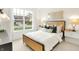 Bright bedroom with a large window offering neighborhood views and a black and wicker bedframe at 9351 Abner St, McCordsville, IN 46055