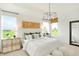 Airy bedroom with a tray ceiling, large windows, and decorative chandelier at 9351 Abner St, McCordsville, IN 46055