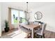 Bright dining room featuring a wood table and seating for six with large windows and views at 9351 Abner St, McCordsville, IN 46055