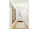 Inviting hallway with hardwood floors and a decorative mirror leading to the main living area at 9351 Abner St, McCordsville, IN 46055