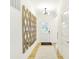 Inviting hallway with hardwood floors and a decorative mirror leading to the main living area at 9351 Abner St, McCordsville, IN 46055