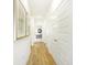 Hallway with hardwood floors and doors on the right that lead to different rooms at 9351 Abner St, McCordsville, IN 46055