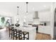 Bright, open kitchen with stainless appliances, granite counters, a center island, and breakfast bar seating at 9351 Abner St, McCordsville, IN 46055