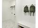 Mudroom boasts marble tile flooring, built-in bench with storage and convenient backpack hooks at 9351 Abner St, McCordsville, IN 46055