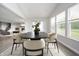 Bright dining room featuring modern table, chairs, large windows, and an open floor plan at 9369 Casey Rd, Pendleton, IN 46064
