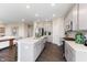 Bright kitchen offers stainless steel appliances, recessed lighting, grey cabinets, hardwood floor and a large center island at 9387 Abner St, McCordsville, IN 46055