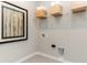 Bright laundry room with wire shelving, wooden crates, and modern decor at 9387 Abner St, McCordsville, IN 46055