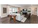 Bright and airy living room with a modern sofa, wood floors, and large windows for plenty of light at 9387 Abner St, McCordsville, IN 46055