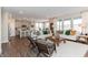 Open-concept living space with hardwood floors, a comfortable sofa, and views of the kitchen at 9387 Abner St, McCordsville, IN 46055