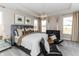 Elegant main bedroom features tray ceilings, a modern chandelier, and plush furnishings at 9387 Abner St, McCordsville, IN 46055