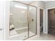 Modern bathroom with glass enclosed shower, built-in bench, and tiled walls at 9387 Abner St, McCordsville, IN 46055