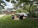 Relaxing backyard with a fire pit area, seating, and lush greenery, perfect for enjoying peaceful evenings outdoors at 949 E Southern Ave, Indianapolis, IN 46203