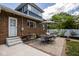 An inviting backyard featuring a brick house and an attractive outdoor dining area with a striped umbrella at 949 E Southern Ave, Indianapolis, IN 46203