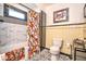 Well-lit bathroom with patterned tile floor, marble-tiled shower, and modern fixtures at 949 E Southern Ave, Indianapolis, IN 46203