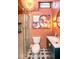 Unique bathroom with peach colored walls, modern vanity, decorative light fixture, and a glass door shower at 949 E Southern Ave, Indianapolis, IN 46203