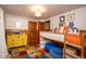 Playful bedroom with a unique bunkbed, colorful dresser, and vibrant rug, perfect for a imagination and comfort at 949 E Southern Ave, Indianapolis, IN 46203