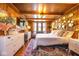 A charming bedroom showcasing wood-paneled walls, a comfy bed, and stylish decor, creating a relaxing and inviting ambiance at 949 E Southern Ave, Indianapolis, IN 46203
