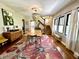 Charming dining room with decorative chandelier, floral rug, and staircase to the upper level at 949 E Southern Ave, Indianapolis, IN 46203