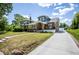 Inviting two-story home featuring manicured lawn, private drive, and traditional brick architecture at 949 E Southern Ave, Indianapolis, IN 46203