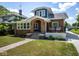 Charming two-story home with brick exterior, an arched entrance, and a cozy front porch at 949 E Southern Ave, Indianapolis, IN 46203