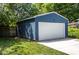 Spacious blue garage with a white door and concrete driveway, offering ample parking and storage space at 949 E Southern Ave, Indianapolis, IN 46203