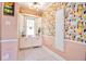 Bright hallway featuring built-in cabinets, colorful wallpaper, and ample natural light at 949 E Southern Ave, Indianapolis, IN 46203