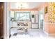 Bright kitchen with white cabinets, colorful decor, and an open layout to a dining area at 949 E Southern Ave, Indianapolis, IN 46203
