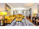 Bright living room showcasing a plush yellow sofa, unique artwork, and stylish décor at 949 E Southern Ave, Indianapolis, IN 46203