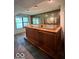 Home wet bar area with wood bar, mirror, and window at 9560 Bay Vista E Dr, Indianapolis, IN 46250