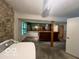 Unfinished basement with a stone accent wall and a bar area perfect for entertaining at 9560 Bay Vista E Dr, Indianapolis, IN 46250