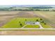 Bird's eye view of a well-kept home, featuring a spacious yard, outbuilding, and long driveway, surrounded by fields at 9605 W 100 S, Jamestown, IN 46147