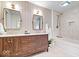 Stylish bathroom featuring a wood vanity, dual sinks, and a bathtub with a tiled shower at 9605 W 100 S, Jamestown, IN 46147