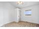 Bedroom featuring light hardwood flooring, white walls, and a bright window with a wooded view at 9605 W 100 S, Jamestown, IN 46147