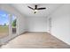 Spacious bedroom with light hardwood flooring, a ceiling fan, and views to a deck at 9605 W 100 S, Jamestown, IN 46147