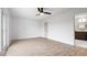 Spacious bedroom with light hardwood flooring, a ceiling fan, and access to a bathroom with double vanity at 9605 W 100 S, Jamestown, IN 46147
