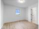 Bedroom features light hardwood flooring, white walls, and a sunny window with a field view at 9605 W 100 S, Jamestown, IN 46147
