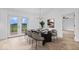 The bright dining room includes a dark table, seating for eight, and a view of the yard and back deck at 9605 W 100 S, Jamestown, IN 46147